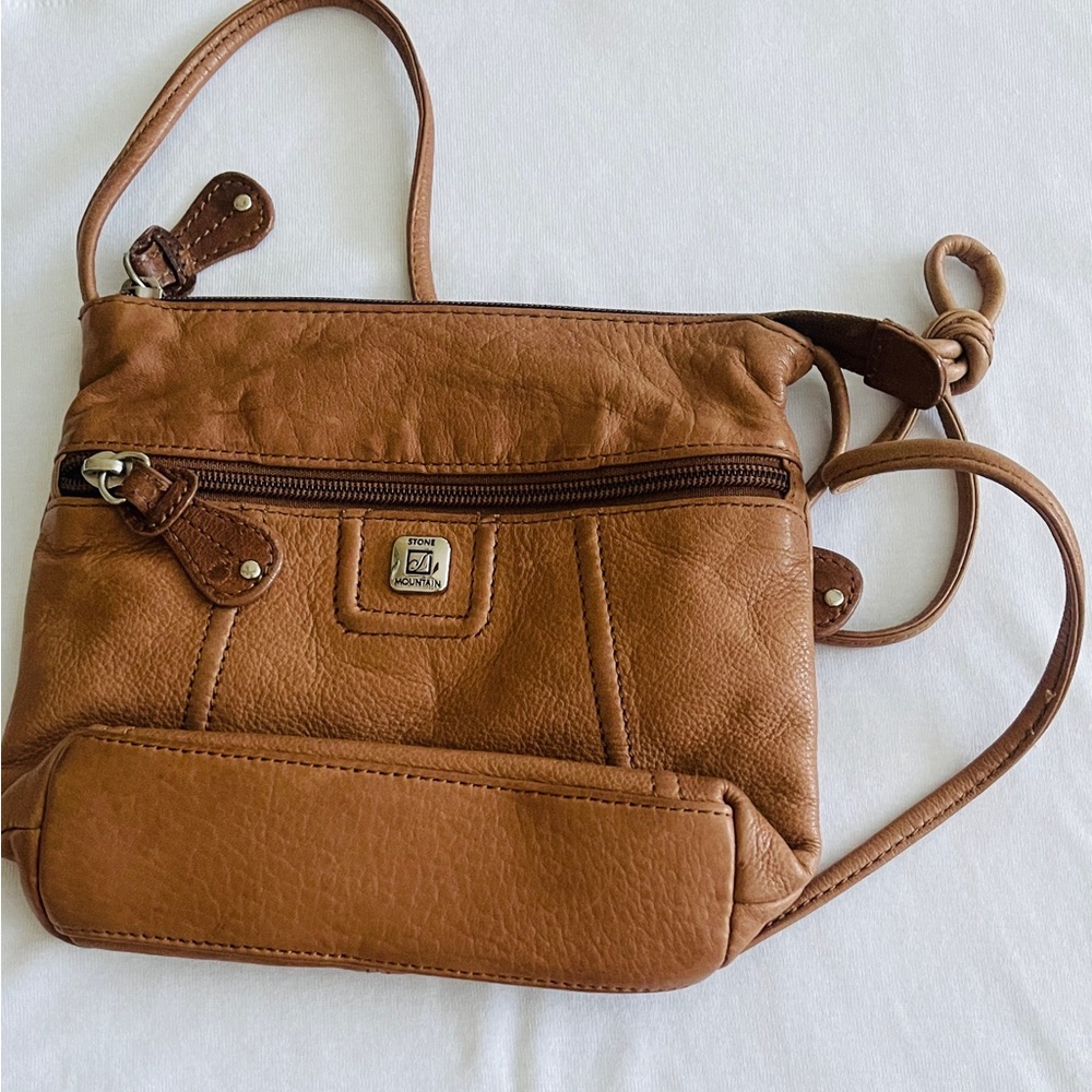 Small Crossbody pocketbook with compartment’s inside and zipper pocket outside.